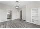 Inviting dining room with modern floors and bright lighting, enhanced by built-in shelving and large windows at 866 W 29Th St, Indianapolis, IN 46208