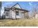 Exterior view of a home highlighting the covered porch, black trim, and updated siding at 866 W 29Th St, Indianapolis, IN 46208
