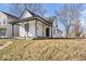 Charming home featuring a covered front porch, complemented by black trim accents and a well-maintained lawn at 866 W 29Th St, Indianapolis, IN 46208
