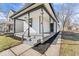 Close-up highlighting a covered front porch with black trim, fresh landscaping, and a welcoming entrance at 866 W 29Th St, Indianapolis, IN 46208