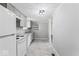 Efficient kitchen featuring gray cabinets and white appliances, creating a clean and functional space at 866 W 29Th St, Indianapolis, IN 46208