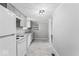 Updated kitchen boasting gray cabinetry, white appliances, and a clean, modern design at 866 W 29Th St, Indianapolis, IN 46208