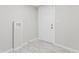 Bright laundry room with marble-style flooring and modern white cabinetry near the entry door at 866 W 29Th St, Indianapolis, IN 46208