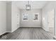 Bright living room featuring hardwood floors, modern lighting, built-in shelving, and two windows at 866 W 29Th St, Indianapolis, IN 46208