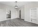 Open-concept living room with hardwood floors, modern lighting, and built-in shelving at 866 W 29Th St, Indianapolis, IN 46208