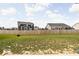 Backyard view with full wooden fence and two homes visible in the background at 1040 Arthur Ct, Greenfield, IN 46140