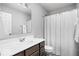 Bright bathroom featuring a modern vanity and shower with white ruffled shower curtain at 1040 Arthur Ct, Greenfield, IN 46140