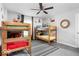 bedroom with two sets of bunkbeds and ceiling fan with Mario themed decor at 1040 Arthur Ct, Greenfield, IN 46140