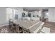 Bright dining room with long table, view into the kitchen, hardwood floors, and natural light at 1040 Arthur Ct, Greenfield, IN 46140