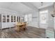 Stylish dining area featuring wood-look floors, built-in display cabinets, and a charming 'Let's Stay Home' sign at 1040 Arthur Ct, Greenfield, IN 46140