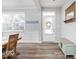 Bright entryway with wood-look floors, decorative wall trim, a bench, coat rack and a charming 'Let's Stay Home' sign at 1040 Arthur Ct, Greenfield, IN 46140