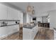 Bright kitchen with white cabinets, granite counters, large island, and stainless steel appliances at 1040 Arthur Ct, Greenfield, IN 46140