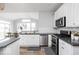 Bright kitchen featuring modern appliances, island, hardwood floors, and natural light at 1040 Arthur Ct, Greenfield, IN 46140