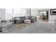 Open-concept living space with a gray sectional sofa, connecting seamlessly to the dining area and kitchen at 1040 Arthur Ct, Greenfield, IN 46140