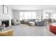 Spacious living room with a fireplace, plush seating, neutral tones, and an open floor plan at 1040 Arthur Ct, Greenfield, IN 46140