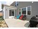 Back patio featuring a concrete patio, colorful chairs, gray siding and a grill at 1040 Arthur Ct, Greenfield, IN 46140