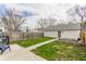 Backyard featuring a detached garage and raised garden beds, enhanced with a wooden fence at 1041 S State Ave, Indianapolis, IN 46203