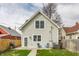 Backyard with a grey two story house, small patio, grill, and lawn at 1041 S State Ave, Indianapolis, IN 46203