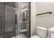 Modern bathroom featuring glass enclosed shower, grey tile surround, and white fixtures at 1041 S State Ave, Indianapolis, IN 46203