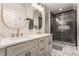 Beautifully remodeled bathroom with a double vanity, gold fixtures, and tiled shower at 1041 S State Ave, Indianapolis, IN 46203