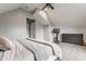 Upstairs bedroom with vaulted ceilings, neutral tones, carpeted floor, and abundant natural light at 1041 S State Ave, Indianapolis, IN 46203