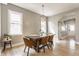 Bright dining room with hardwood floors, modern light fixture, and large windows at 1041 S State Ave, Indianapolis, IN 46203