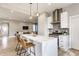 Open kitchen featuring quartz island, stainless appliances, pendant lights, and breakfast bar at 1041 S State Ave, Indianapolis, IN 46203