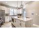 Gourmet kitchen featuring quartz island, stainless appliances, pendant lights, and custom cabinetry at 1041 S State Ave, Indianapolis, IN 46203