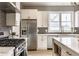 Open kitchen features stainless steel appliances, grey tile backsplash, and breakfast bar seating at 1041 S State Ave, Indianapolis, IN 46203