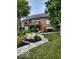 Charming home featuring a beautiful backyard with a stone walkway, leading to a multi-tiered deck at 113 Edgewater Dr, Noblesville, IN 46062