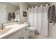 Bright bathroom features a vanity with a sink, toilet, shower and a neutral color palette, creating a clean and functional space at 113 Edgewater Dr, Noblesville, IN 46062