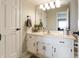 Bright bathroom featuring a white vanity with marble countertop and large mirror at 113 Edgewater Dr, Noblesville, IN 46062