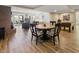 Dining area features a round table with seating for four, wood floors, and natural light from sliding glass doors at 113 Edgewater Dr, Noblesville, IN 46062