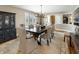 Elegant dining room with a large table, chandelier, and a decorative cabinet at 113 Edgewater Dr, Noblesville, IN 46062