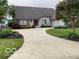 Beautiful home featuring a well-manicured lawn, attractive landscaping, and a spacious driveway at 113 Edgewater Dr, Noblesville, IN 46062