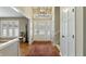 Bright foyer with a decorative front door, chandelier, hardwood floor, and staircase at 113 Edgewater Dr, Noblesville, IN 46062