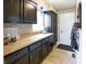 Galley kitchen with dark lower cabinets and light countertops, creating a modern contrast at 113 Edgewater Dr, Noblesville, IN 46062
