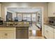 A kitchen view into the breakfast nook with water views and a built in shelving unit at 113 Edgewater Dr, Noblesville, IN 46062
