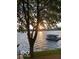 Scenic lake view featuring a boat dock and a tranquil sunset, creating a serene atmosphere at 113 Edgewater Dr, Noblesville, IN 46062