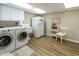 Convenient laundry room with modern washer and dryer, storage cabinets, and utility sink at 113 Edgewater Dr, Noblesville, IN 46062