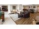 Open-concept living room features a tan sofa, wood floors, and neutral tones, creating a welcoming and stylish atmosphere at 113 Edgewater Dr, Noblesville, IN 46062