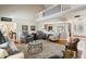 Open-concept living room with hardwood floors, a comfortable seating arrangement, and ample natural light at 113 Edgewater Dr, Noblesville, IN 46062