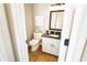 Powder room features a granite countertop, vanity, new toilet and decorative wall art at 113 Edgewater Dr, Noblesville, IN 46062