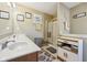Bathroom featuring a double sink vanity, shower, and decorative accents at 11624 Eldridge Dr, Indianapolis, IN 46235
