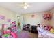 Well-lit bedroom with a ceiling fan, neutral walls, and colorful decorations at 11624 Eldridge Dr, Indianapolis, IN 46235
