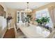 Elegant dining room with a chandelier, large windows, and a glass display cabinet at 11624 Eldridge Dr, Indianapolis, IN 46235