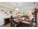 Dining area with hardwood floors leading to living area with a TV at 11624 Eldridge Dr, Indianapolis, IN 46235