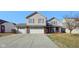 Charming two-story home with a three-car garage and well-maintained front yard on a sunny day at 11624 Eldridge Dr, Indianapolis, IN 46235