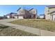 Well-maintained two-story home with three-car garage, green lawn and sidewalk at 11624 Eldridge Dr, Indianapolis, IN 46235