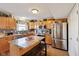 Well-lit kitchen featuring stainless steel appliances and an island with seating at 11624 Eldridge Dr, Indianapolis, IN 46235